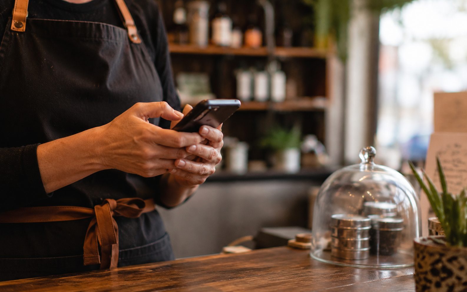 Vernon BC customer leaving a Google review on their phone at a business counter